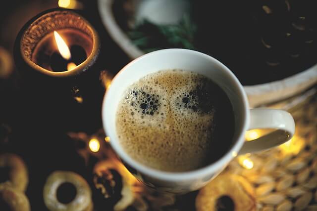 coffee and candle, coffee often symbolizes stimulation, energy, and the need for a wake-up call