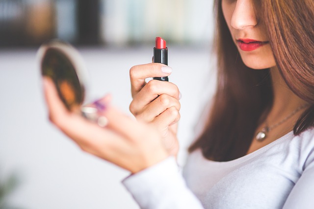 Applying Red Lipstick in Front of a Mirror